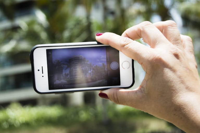 Photography of Person Holding an Iphone 5s